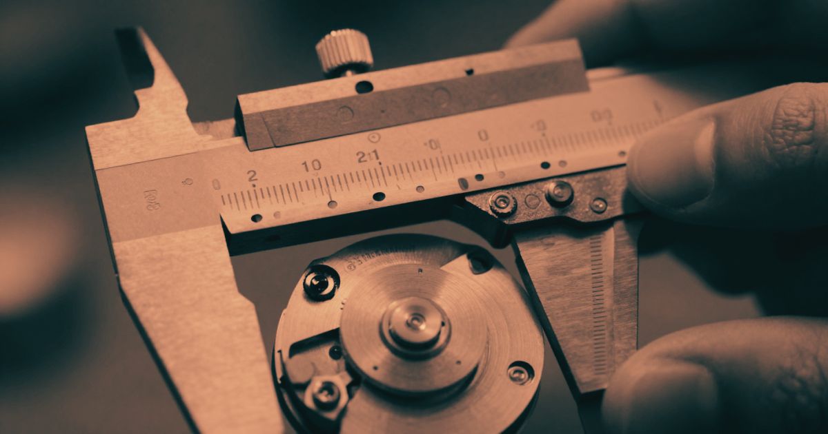 Extreme close-up of a precision instrument being calibrated, hands only